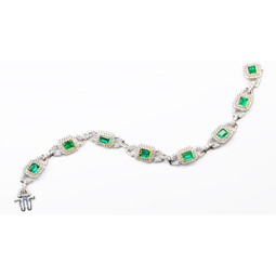 8-3.64 Emerald Cut Emerald Bracelet set with 472-3.66 White Melee Round Diamonds. Set in 18KWG & 18KYG with 25.57 grms.