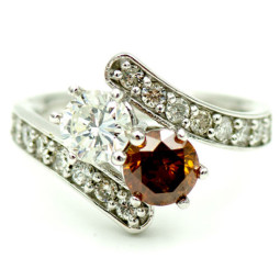 A 0.70ct Round Brilliant I-SI1 and a 0.87ct Round Brilliant Fancy Deep brownish Orange Set in a White Gold 14Kt Ring